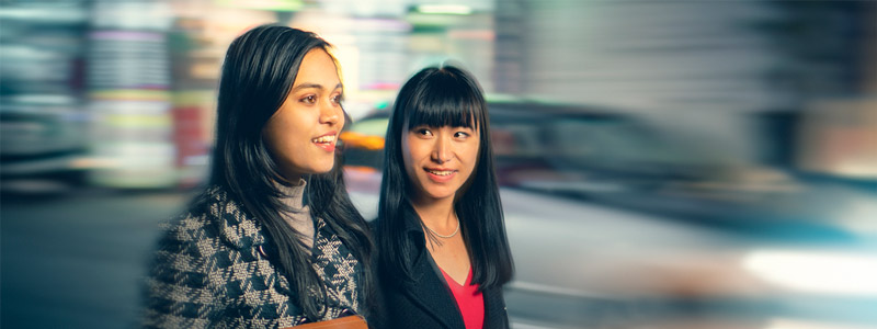 2 ladies walking along a street