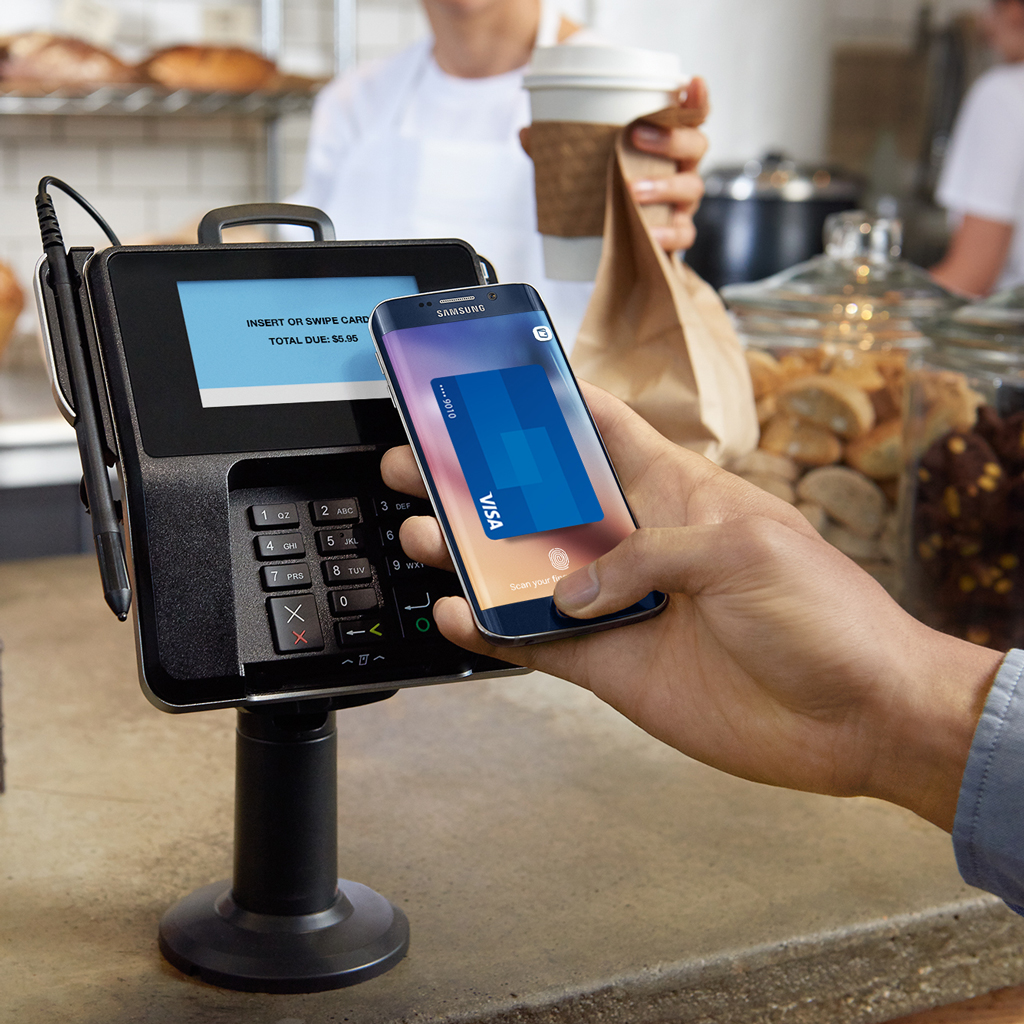 Customer waving their smart phone to make a seamless payment at a business
