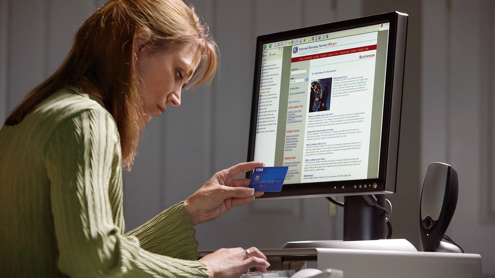 A woman doing a secure online payment with her Visa card