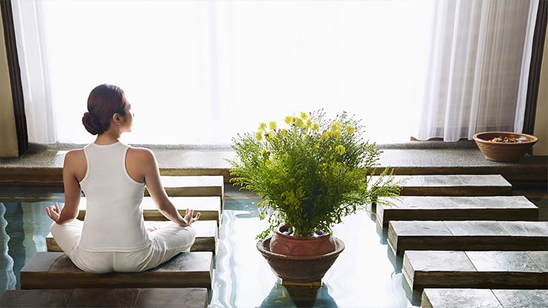 lady sitting in a meditative pose