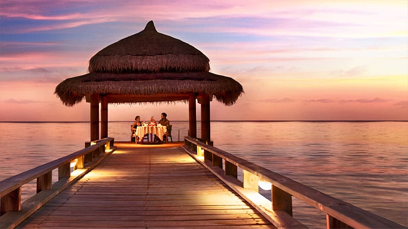 couple having dinner in a hut